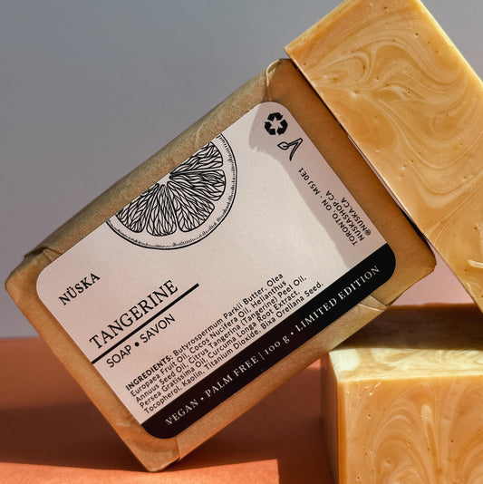 A rectangular bar of Nuska Tangerine Soap with a label featuring tangerine slices.